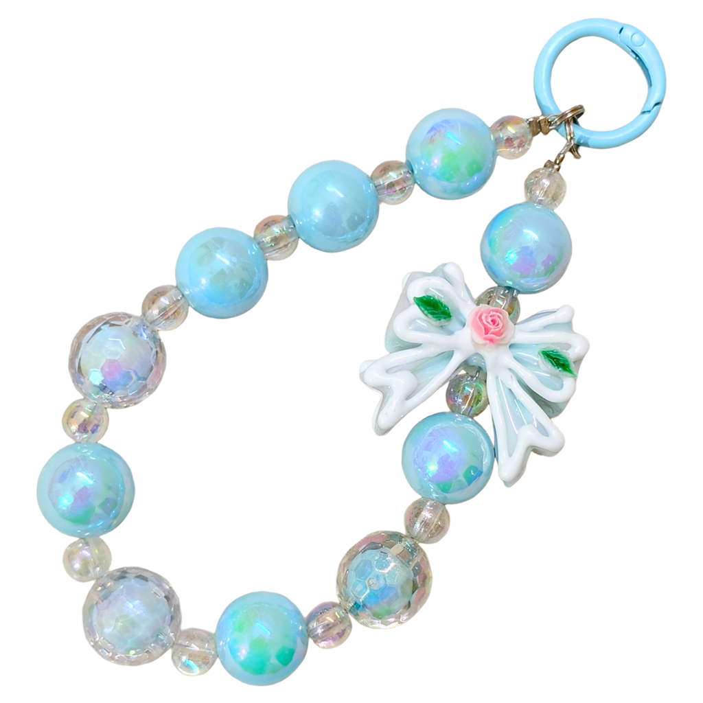 Bracelet with blue beads and butterfly charm on a white background