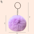 Purple fluffy keychain with measurements on a beige background