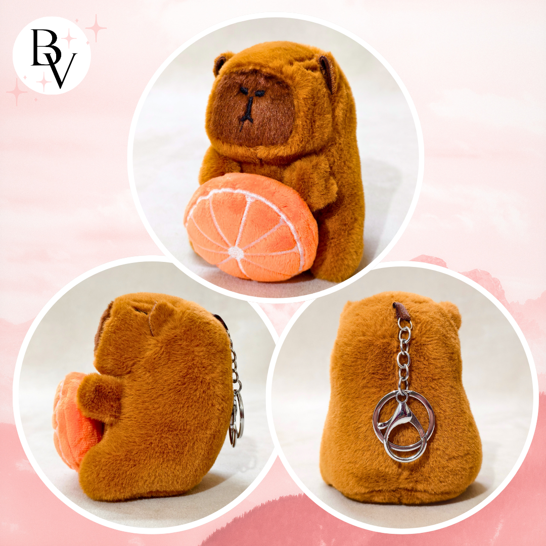 Brown bear-shaped keychain with salmon and keyring on a pink background