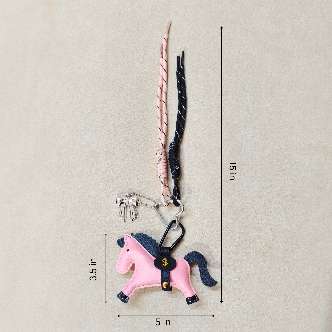 Pink horse-shaped keychain with measurement details on a beige background