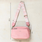 Pink pebbled faux-leather crossbody bag with a wide pink-and-white chevron patterned strap, shown with dimension lines indicating 20 in height, 9 in width, and 6 in depth on a light beige background.