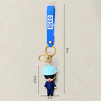 Keychain with character figure and blue strap labeled 'HERO' on a beige background