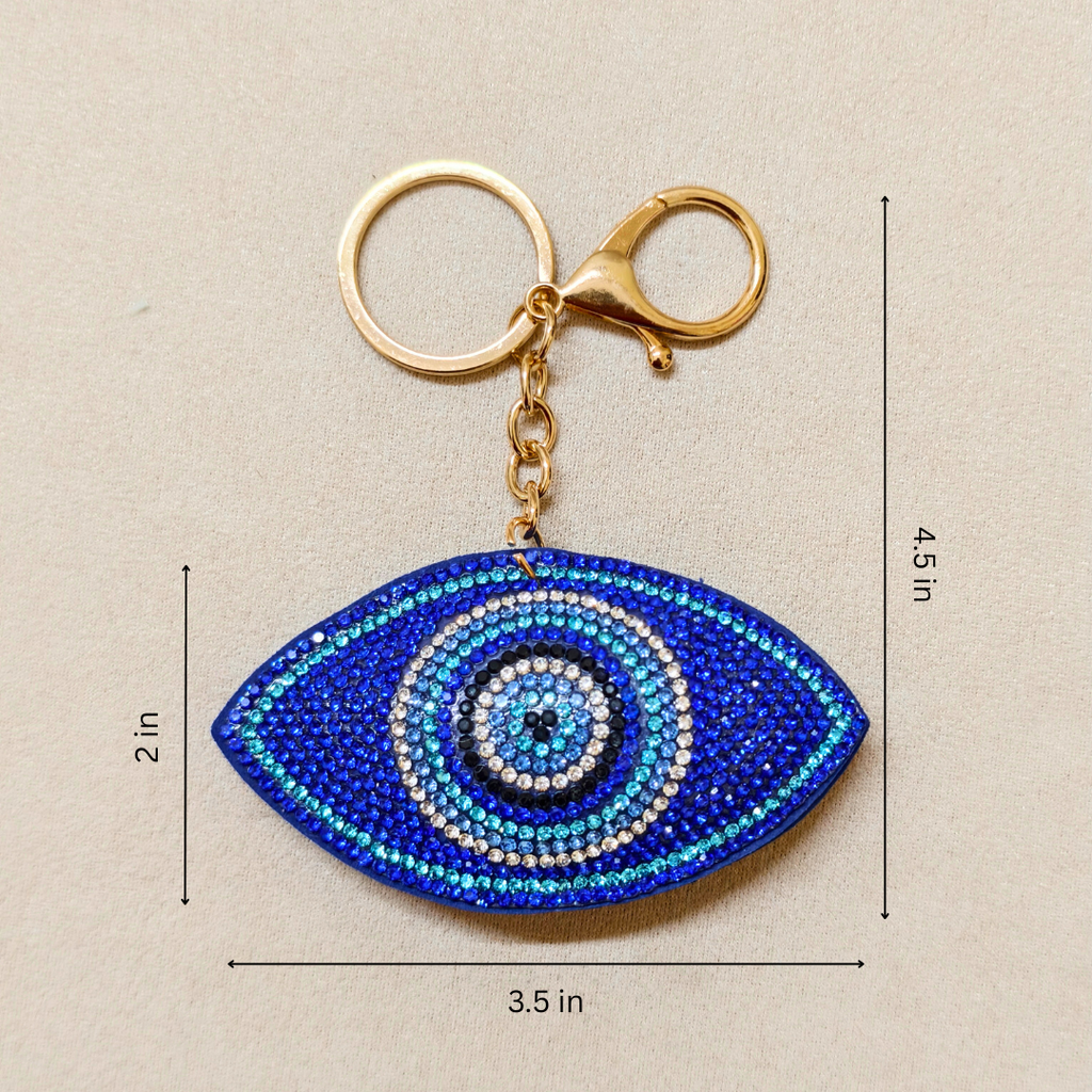 Blue eye-shaped keychain with measurements on a beige background