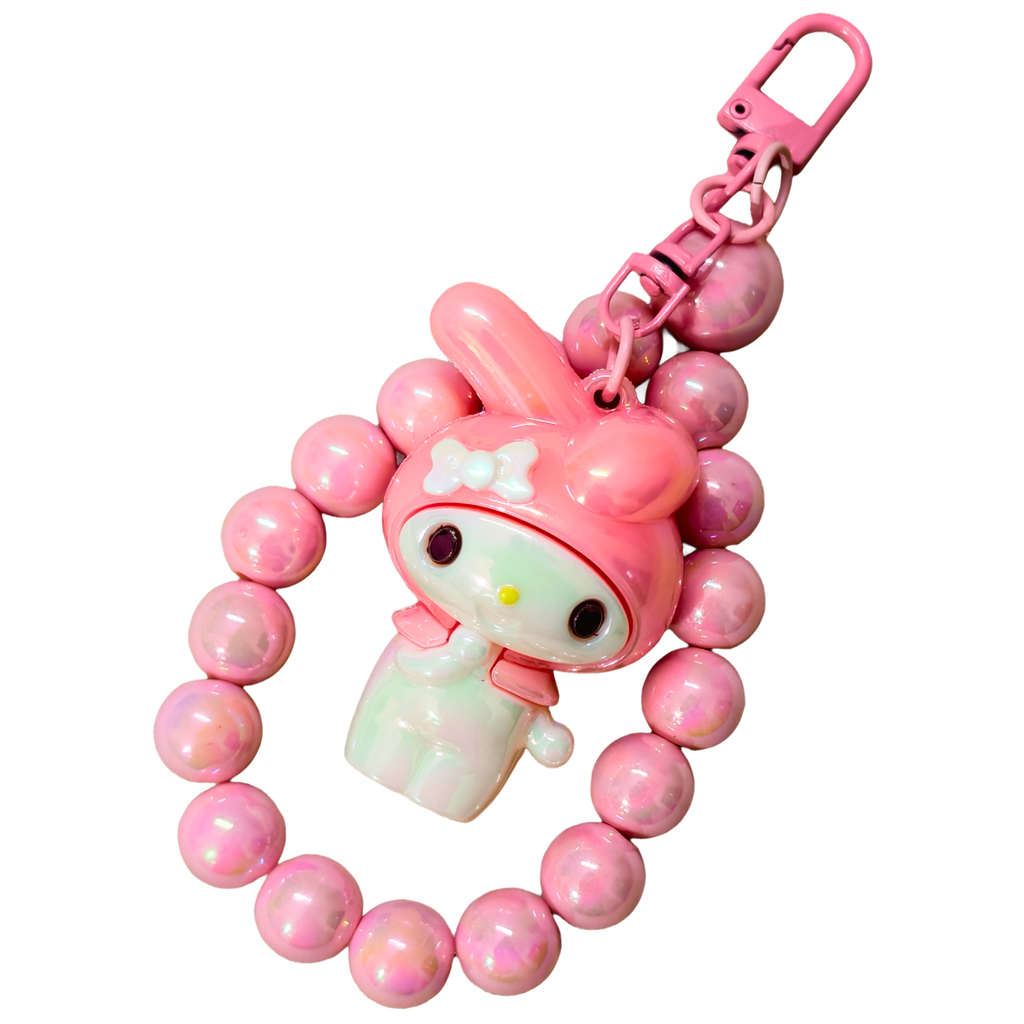 Pink character keychain with beads on a white background