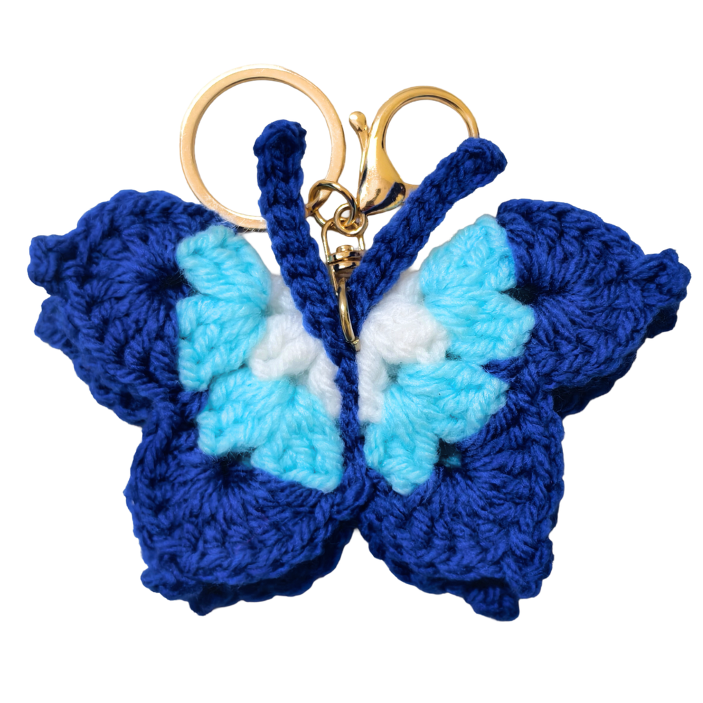 Blue and turquoise butterfly keychain with gold ring on a white background