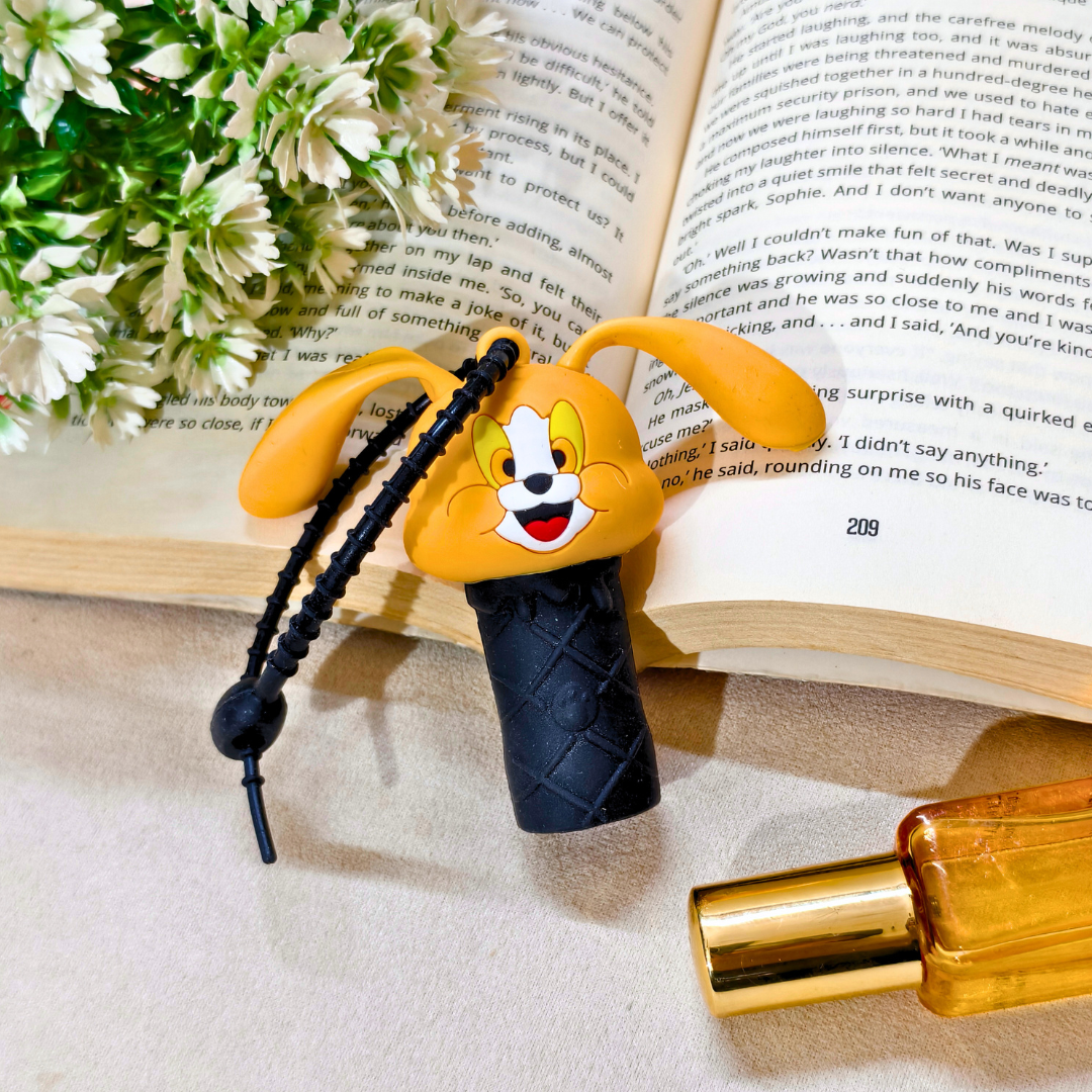 Cartoon dog-shaped bottle cap on a book with a perfume bottle and flowers in the background
