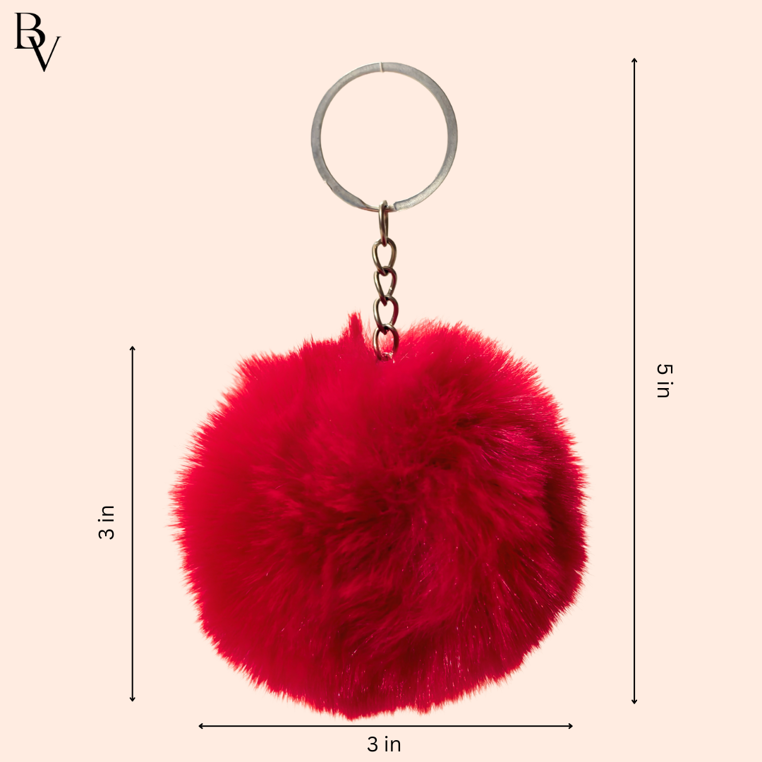 Key Chain Showing Measurement In Front Of White Background.