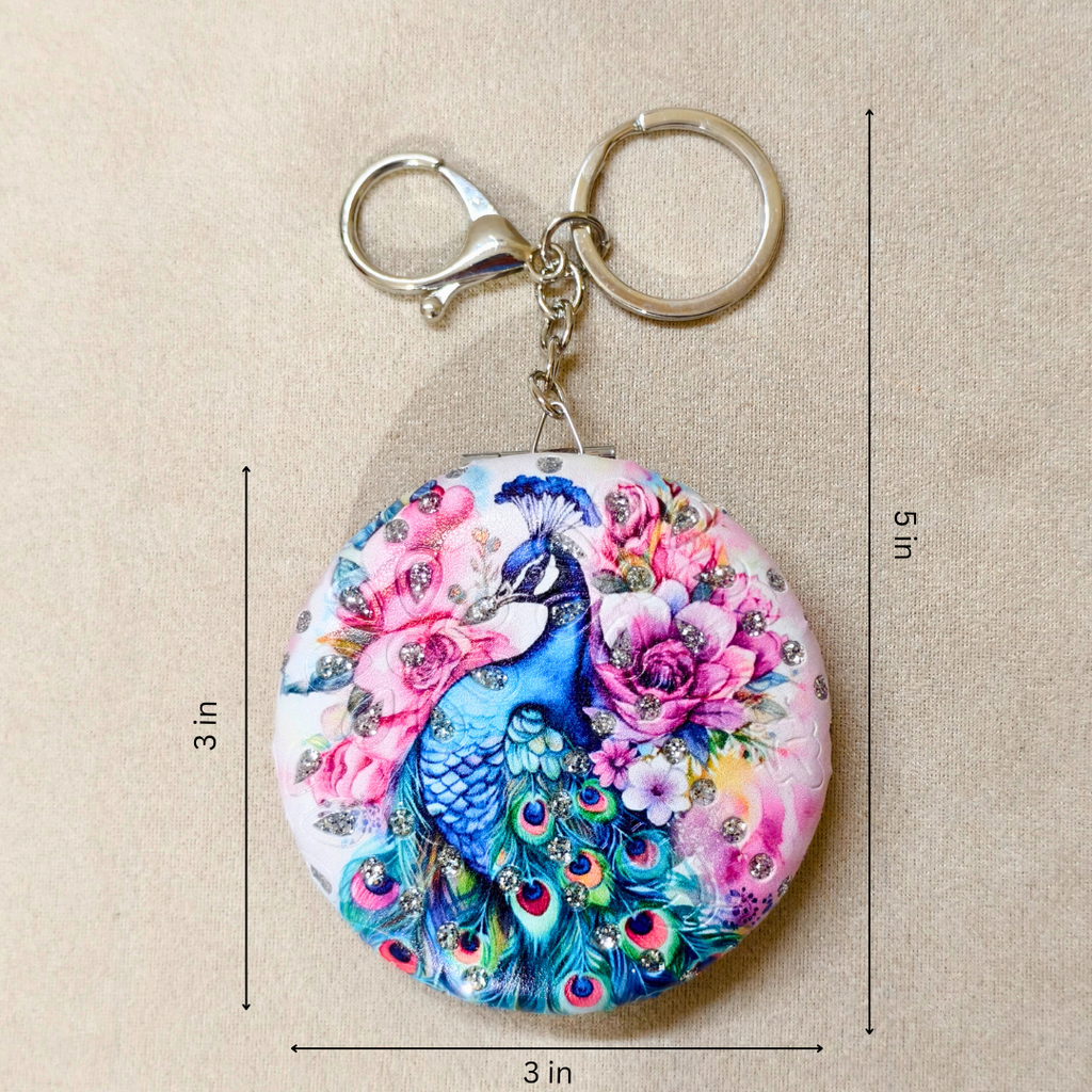 Keychain with peacock and floral design, shown with measurements on a beige background