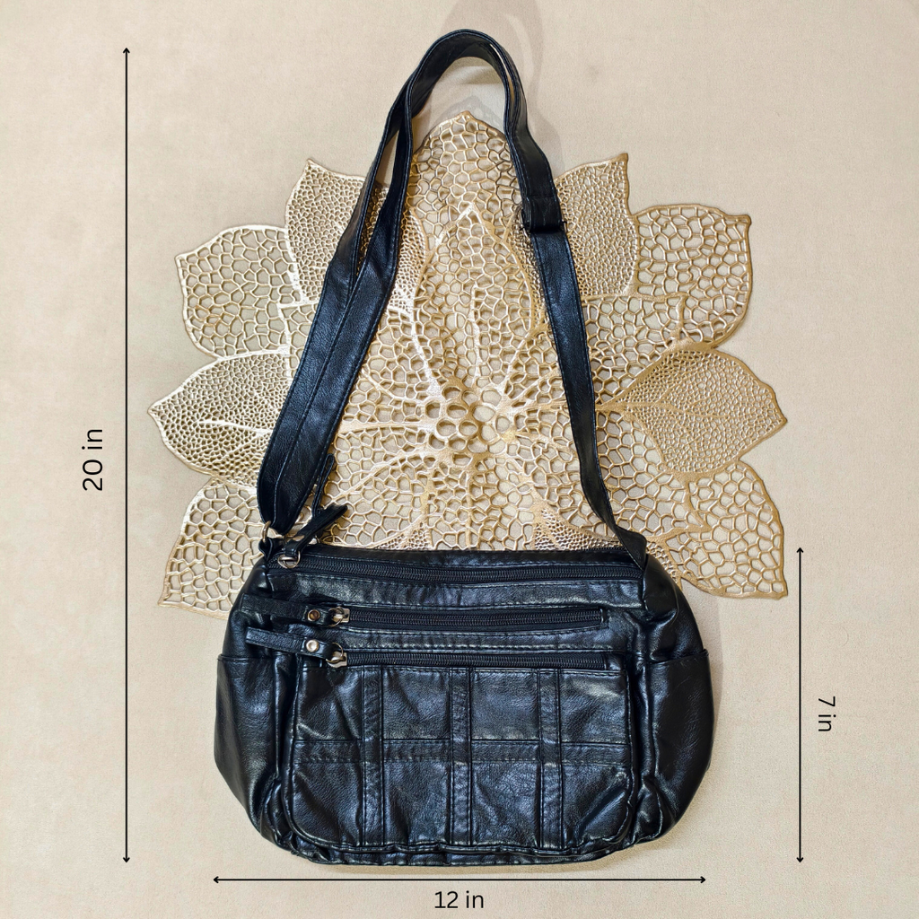 Black leather handbag with measurements on a beige background