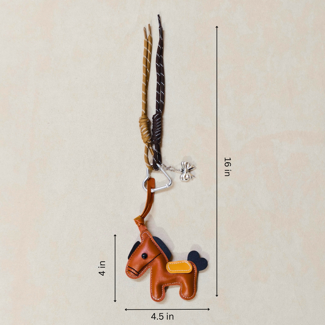 Brown horse-shaped keychain with long antlers on a beige background with measurements.
