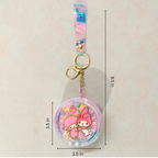 Keychain with cartoon characters and measurements on a beige background
