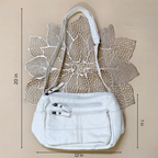 White handbag with measurements on a beige background