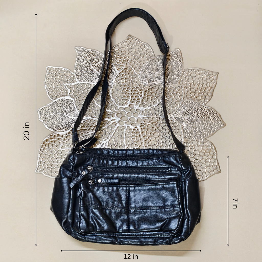 Black handbag with measurements on a beige background
