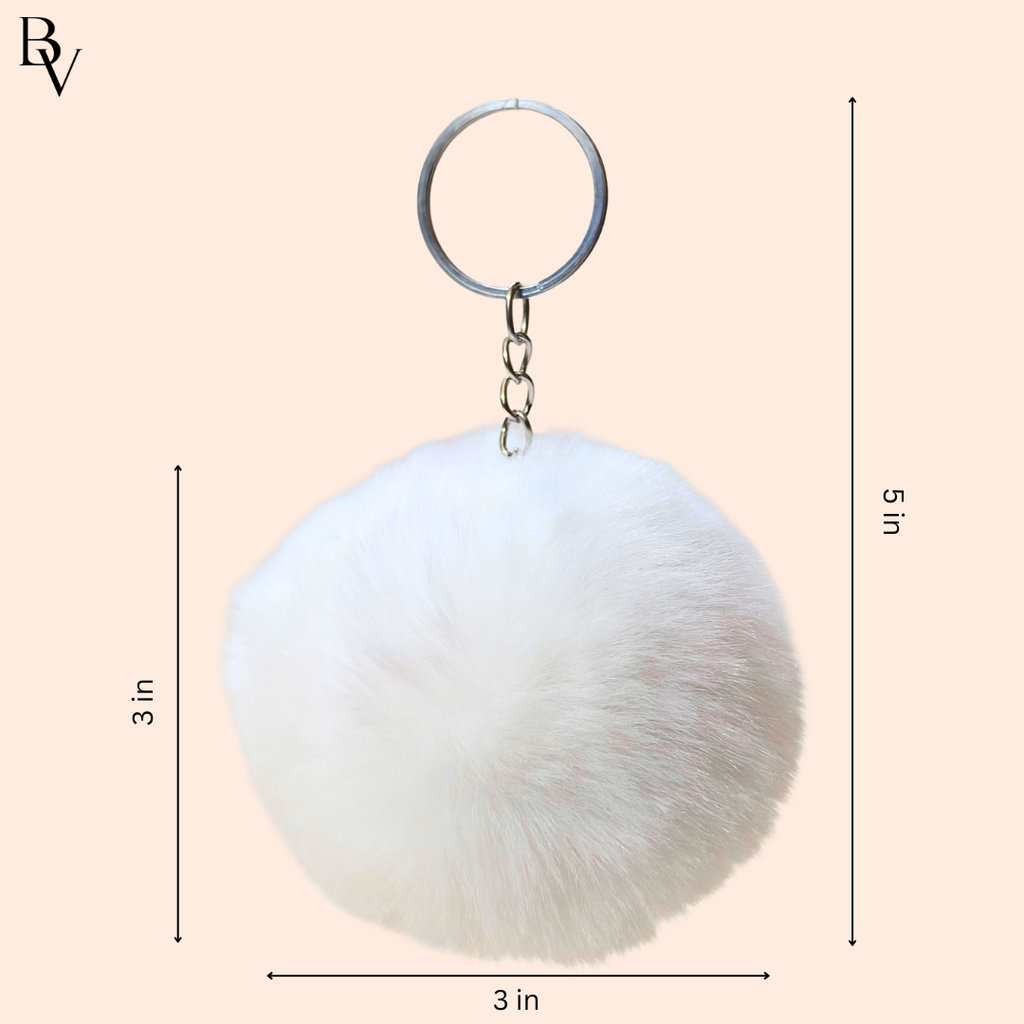White fluffy keychain with dimensions on a beige background