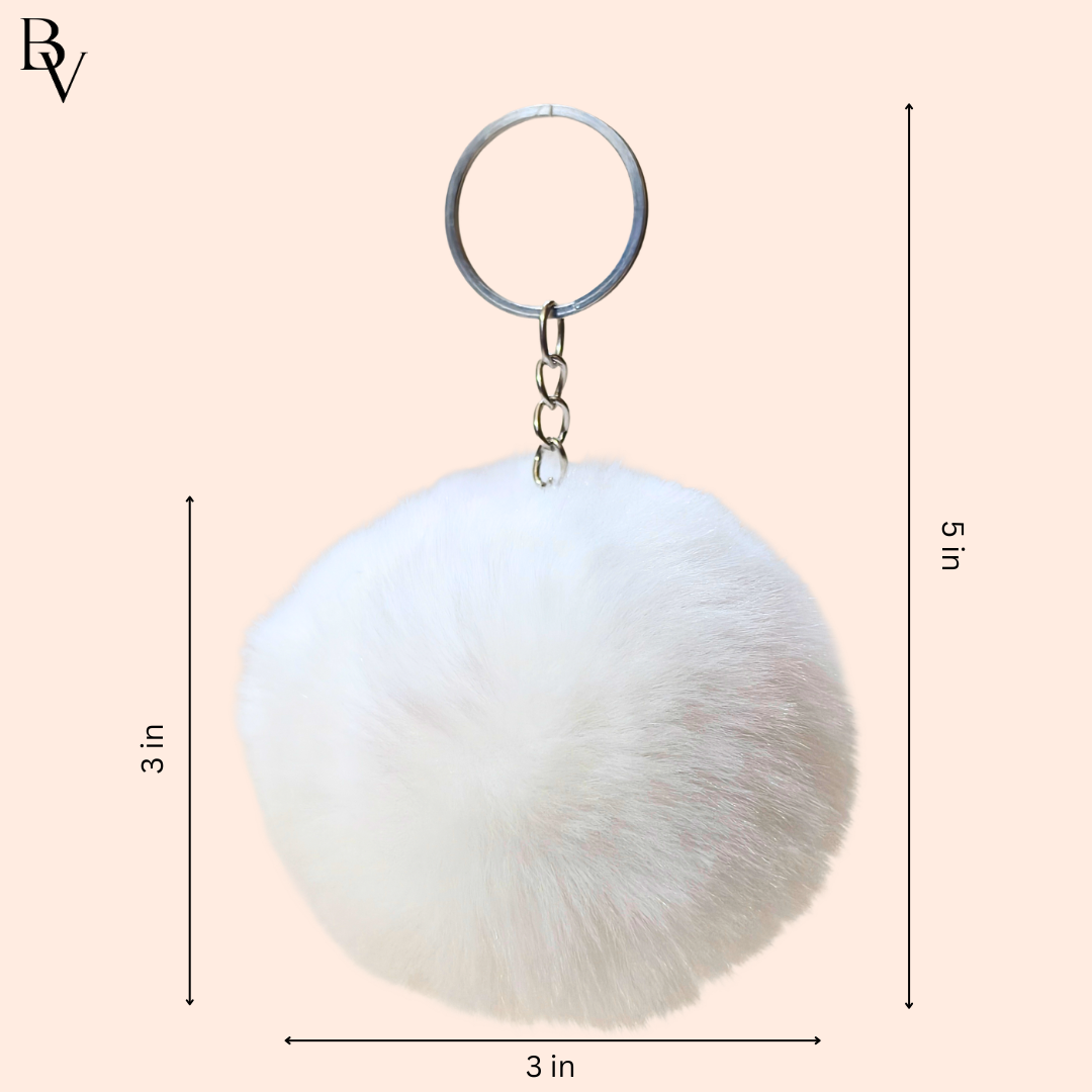 White fluffy keychain with dimensions on a beige background