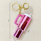 A pink metallic tumbler keychain with a handle and gold key ring, shown on a beige background with black dimension lines and text indicating measurements of 6 in, 3.5 in, and 2.