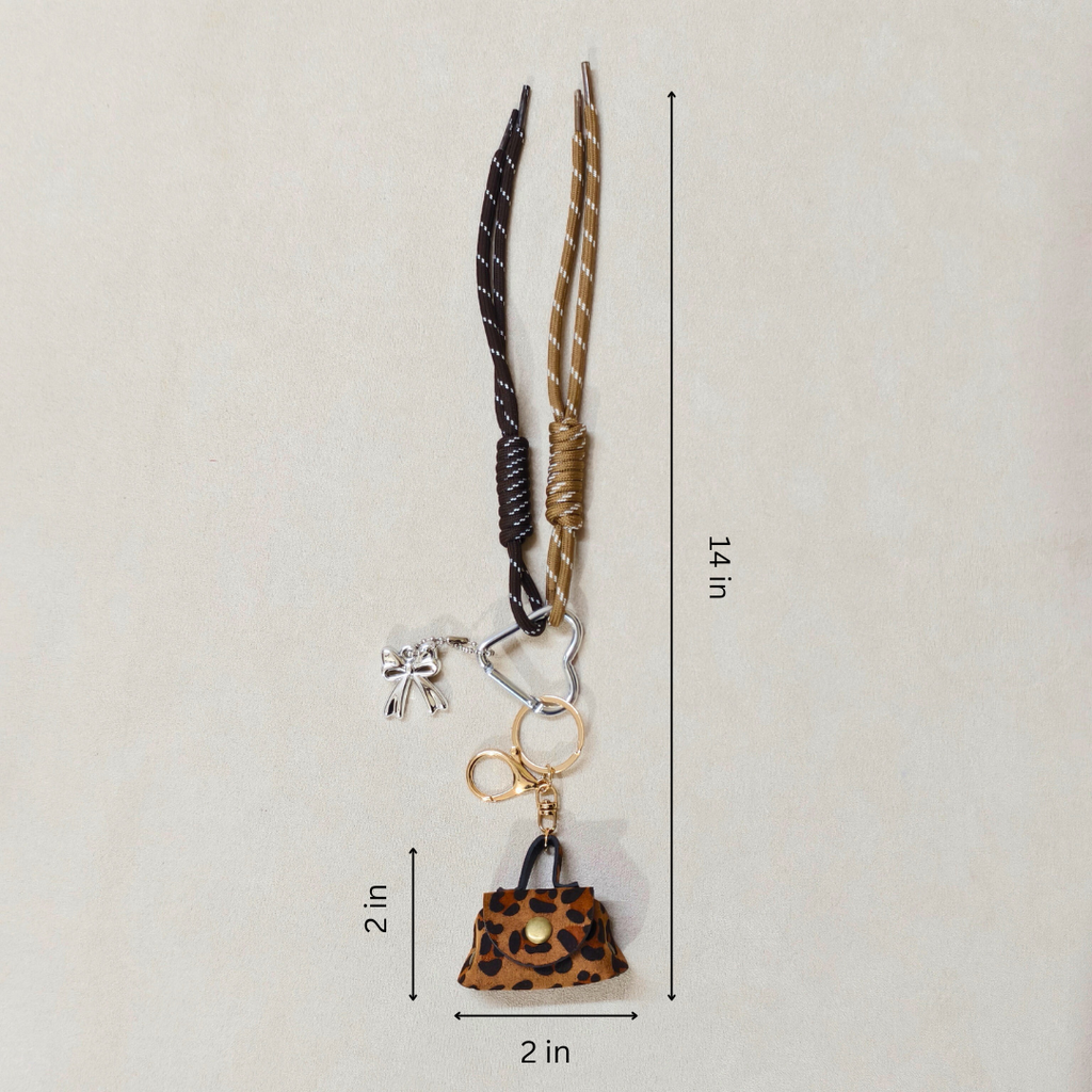 Keychain with leopard print purse charm and measurement details on a beige background