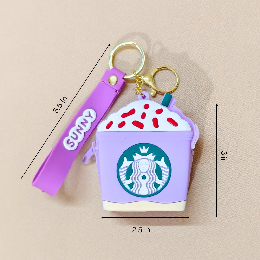 Starbucks-themed purple air pod case with a keychain on a beige background