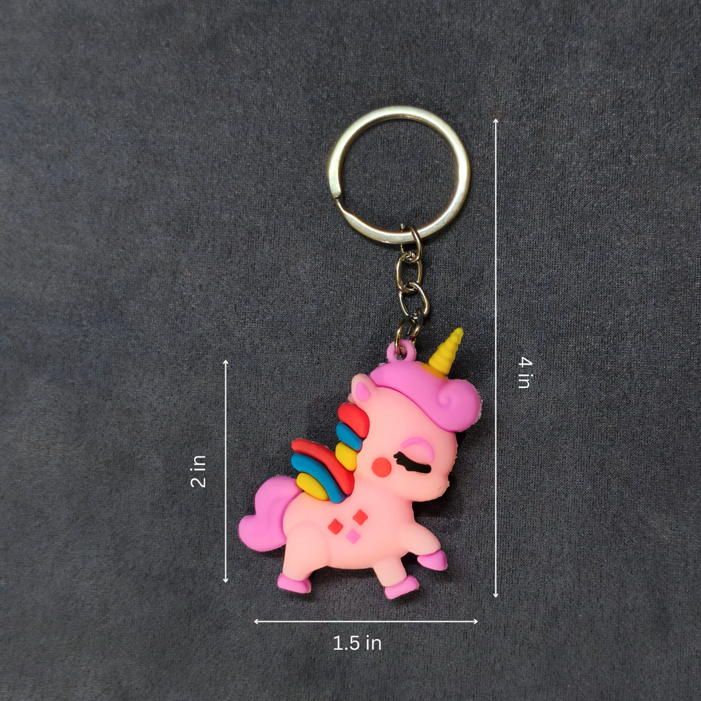 Pink unicorn keychain with measurements on a dark gray background