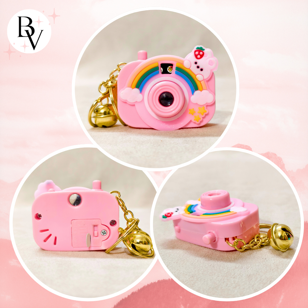 Pink toy camera with cat ears and rainbow design on a pink background