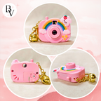 Pink toy camera with cat ears and rainbow design on a pink background