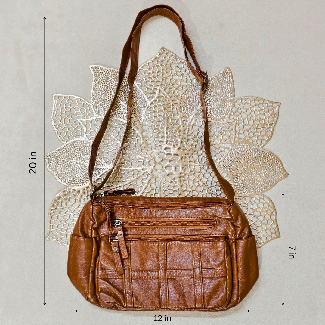 Brown leather handbag with measurements on a textured beige background