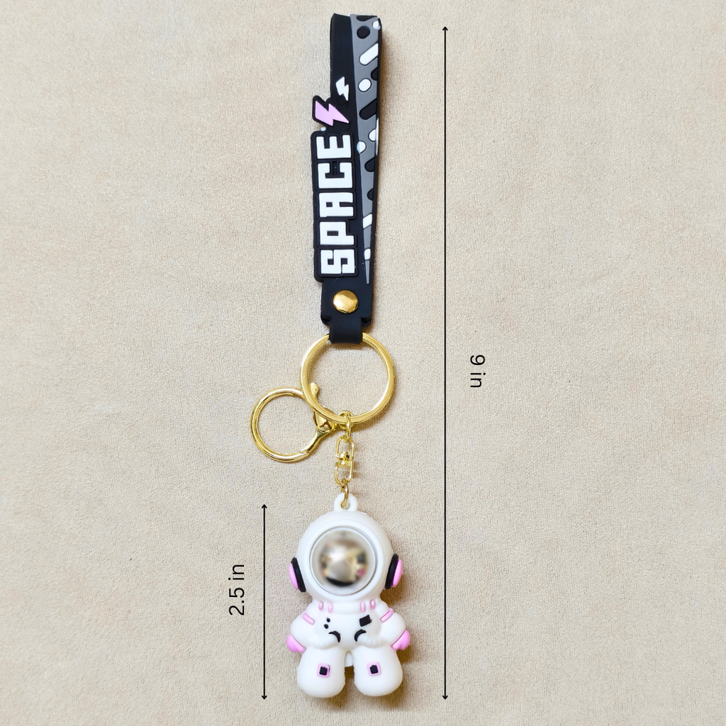 Small Astronaut Keyring With Measurements  On Beige Background.