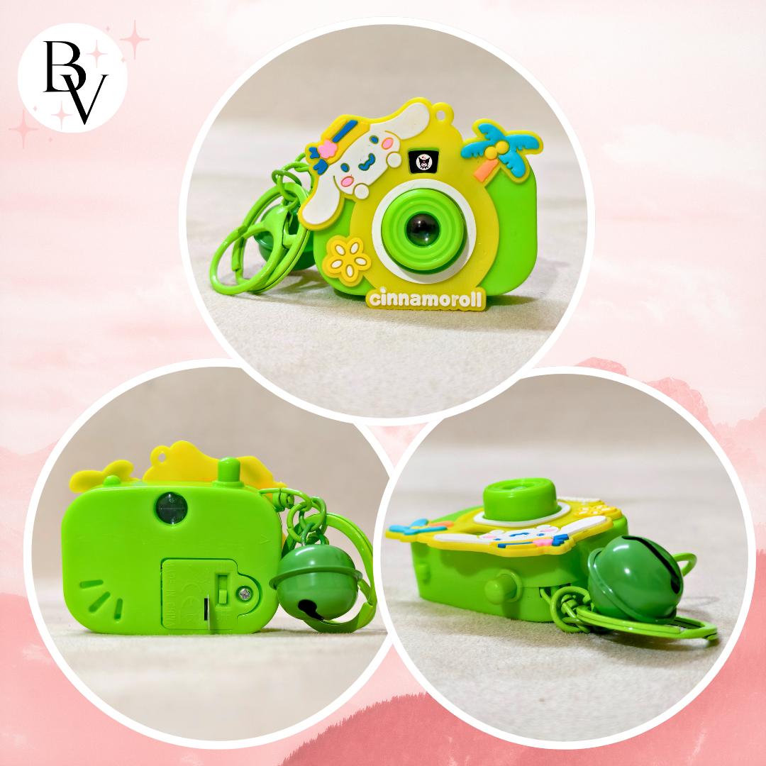 Green toy camera with colorful design on a pink background