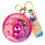 Pink keychain with a cartoon bear design on a white background