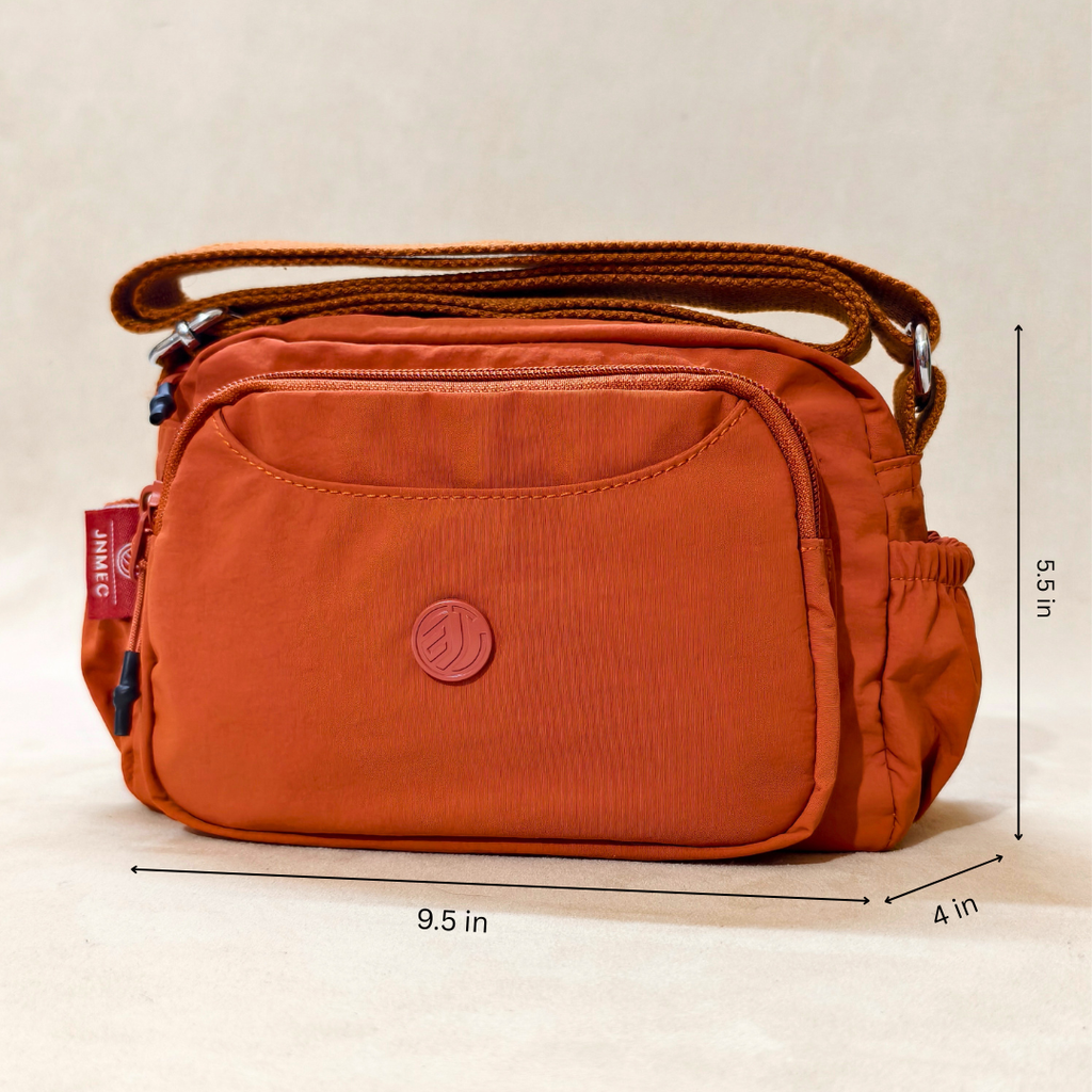 Rust Brown Sling Bag With Measurements In Front Of Beige Background.