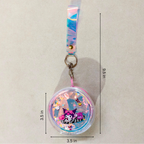Keychain with cartoon character inside a transparent dome, measurements indicated on a beige background