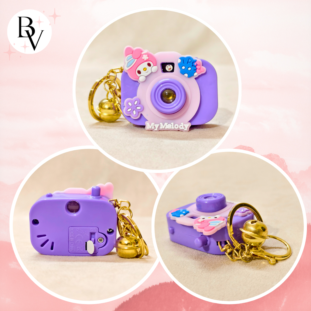 Purple toy camera with floral decorations and gold chain on a pink background