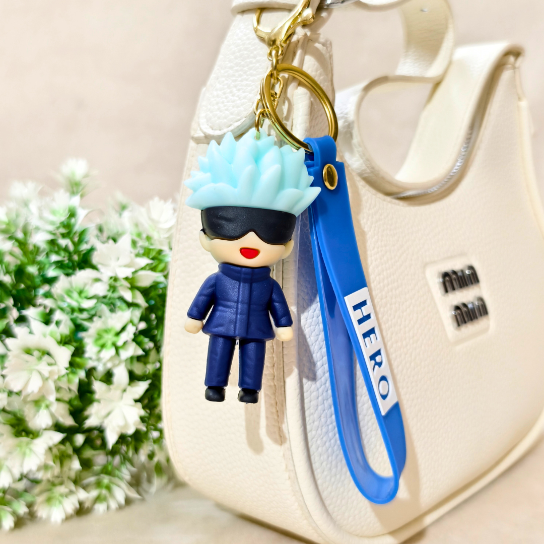 Keychain with a character figure and blue strap on a beige bag with flowers in the background
