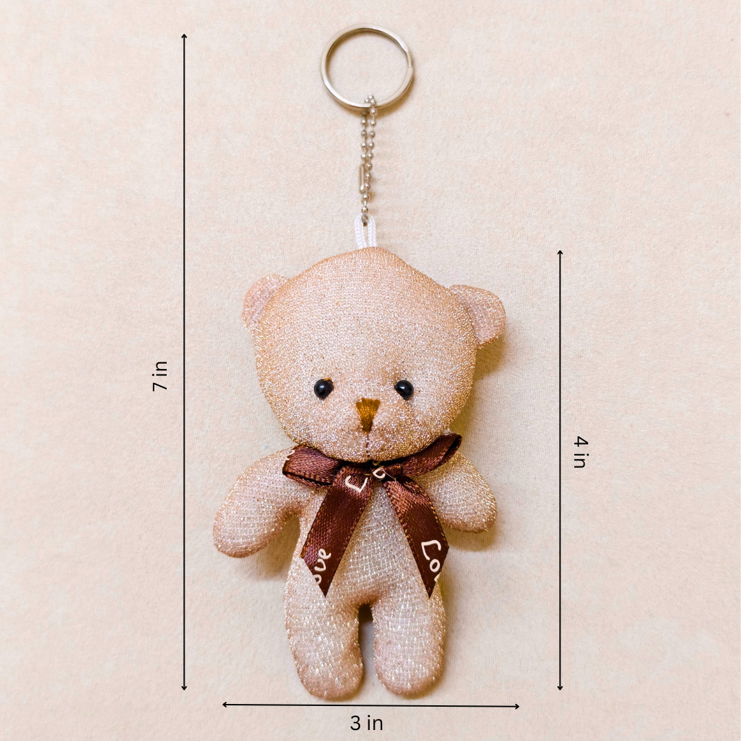 Teddy bear keychain with dimensions on a beige background