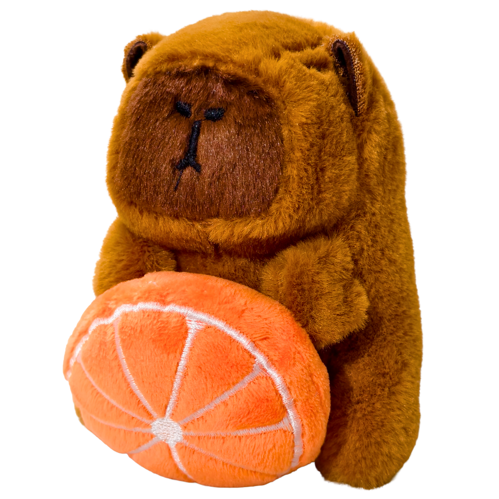 Plush bear holding an orange on a white background