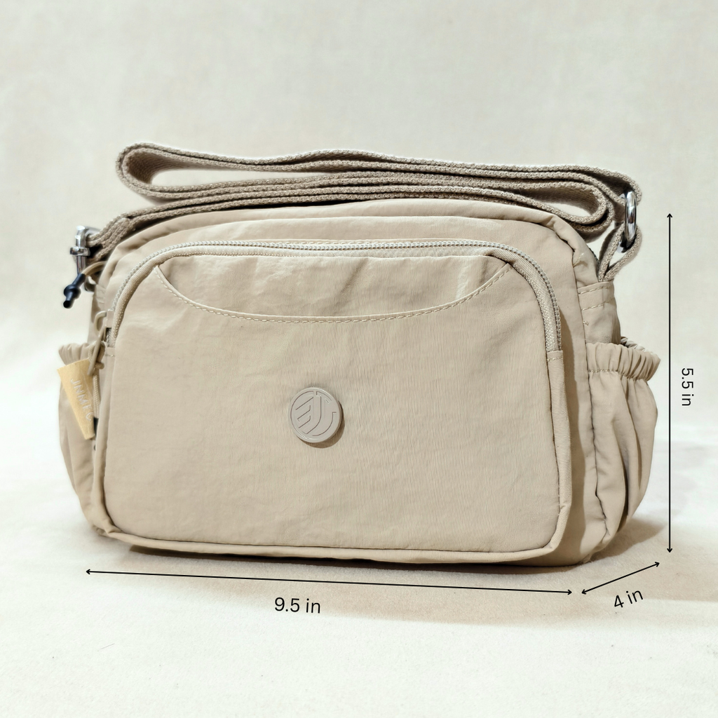 Khaki Beige Sling Bag With Measurements In Front Of Beige Background.