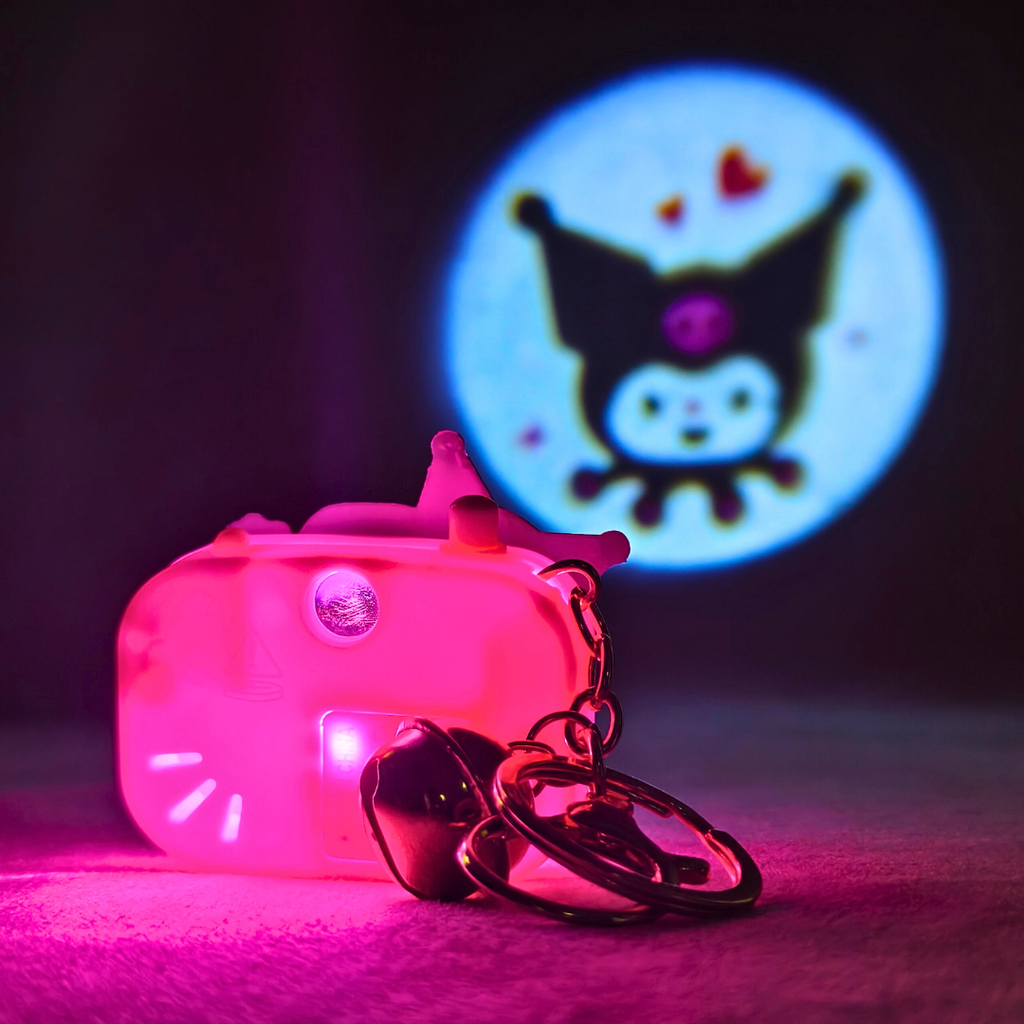 Pink toy camera with keychain on a dark background