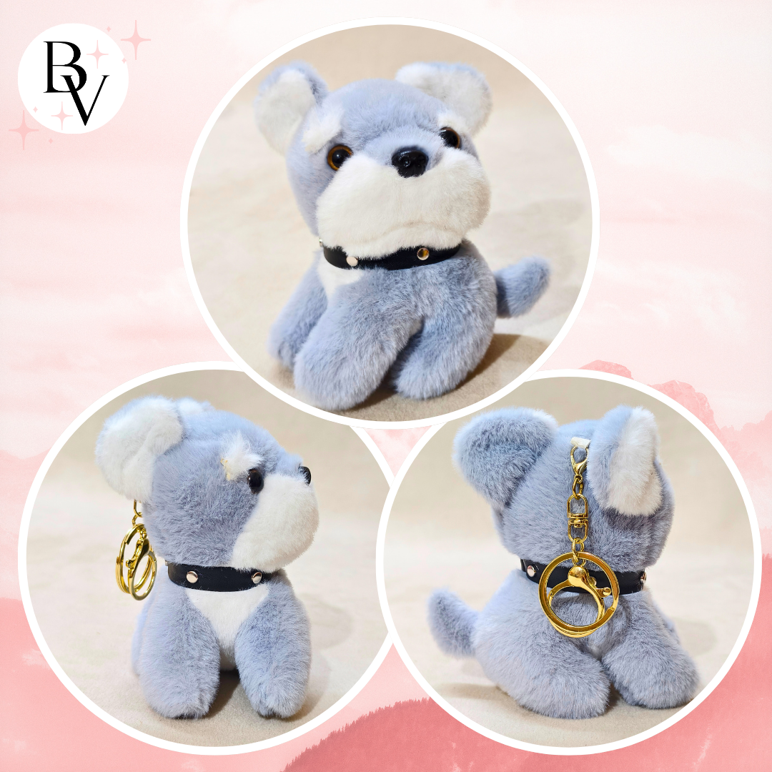Plush dog toy with a keychain attachment on a pink background