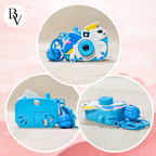 Blue toy camera with colorful design on a pink background