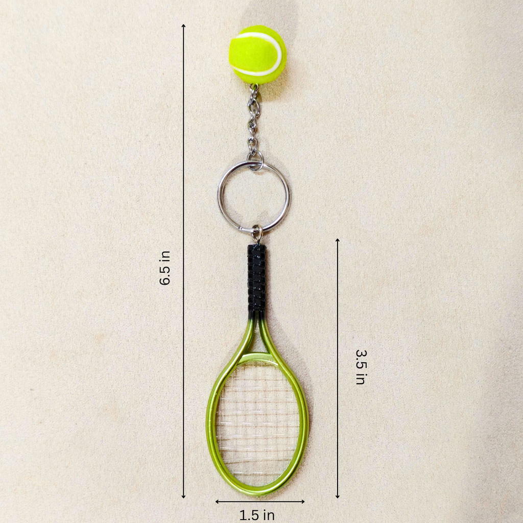 A tennis-themed keychain featuring a miniature lime green tennis ball attached to a silver chain, a silver key ring, and a small lime green tennis racket with a black grip. The image includes dimension lines and text indicating measurements: 6.