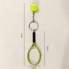 A tennis-themed keychain featuring a miniature lime green tennis ball attached to a silver chain, a silver key ring, and a small lime green tennis racket with a black grip. The image includes dimension lines and text indicating measurements: 6.