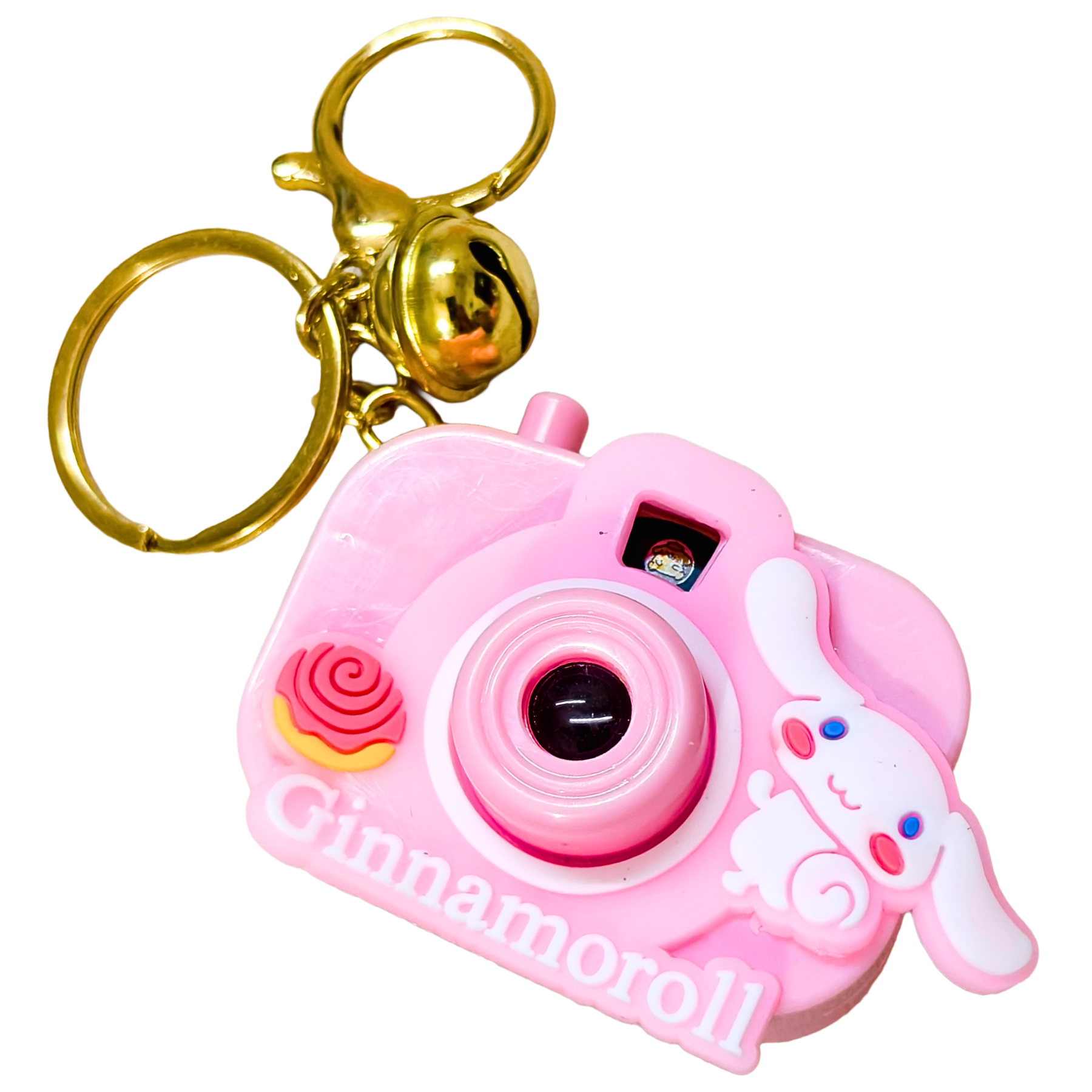 Pink camera-shaped keychain with a gold ring on a white background