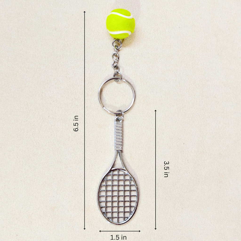A tennis racket keychain with a bright yellow tennis ball charm at the top, shown on a light beige background with dimension lines indicating measurements of 6.5 inches in height, 3.