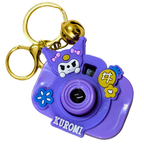 Purple camera-shaped keychain with cartoon character and 'Kuromi' branding on a white background