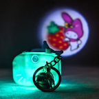 Glowing green keychain with a cartoon character in the background