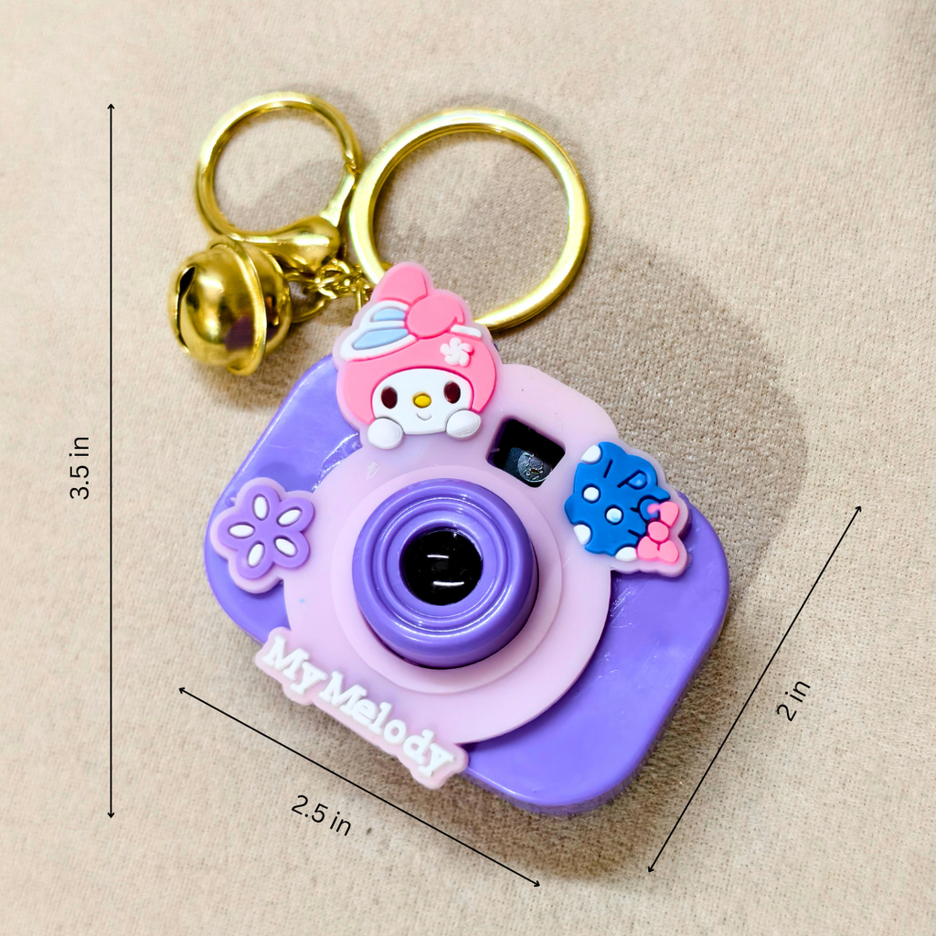 Purple camera-shaped keychain with cartoon character and measurements on a beige background