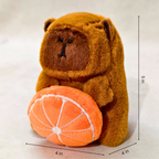 Plush bear holding an orange with dimensions indicated on a white background