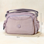 Lavender Lilac Sling Bag With Measurements In Front Of Beige Background. 