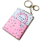 A pink and white handbag-shaped keychain wallet with rhinestone embellishments, a clasp closure, and a gold-tone key ring on a white background.