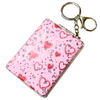 A pink rectangular card holder or compact-style case with a silver metal frame and attached gold-tone key ring and chain, decorated with red hearts and rhinestone-like sparkles on a white background.